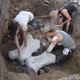 Students make protective plaster wrappings for asphalt-preserved giant sloth bones at the Tanque Loma tar pit locality in southwestern Ecuador.
